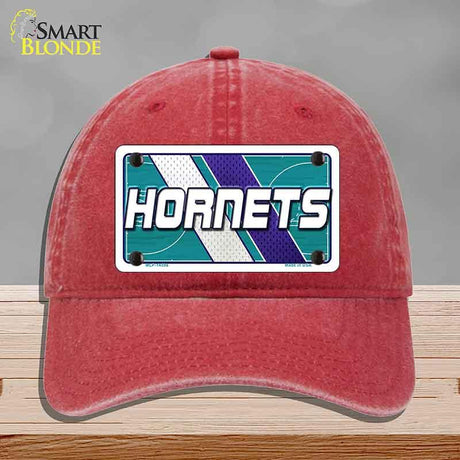 Red cap with Hornets logo on a gray background