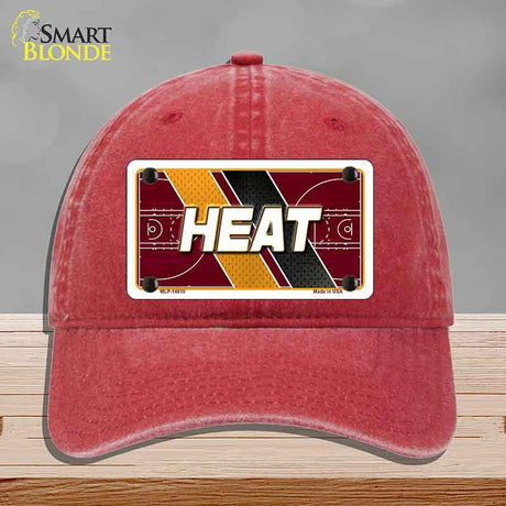 Red cap with 'HEAT' design on a gray background