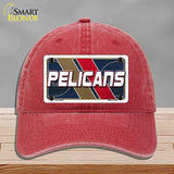 Red cap with 'Pelicans' logo on a gray background