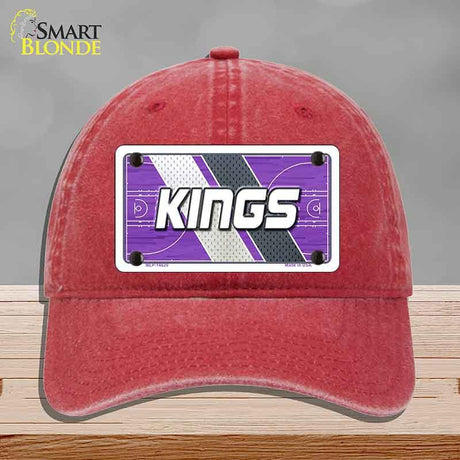 Red cap with a 'KINGS' logo on a gray background