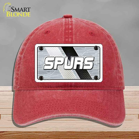Red cap with 'SPURS' logo on a gray background