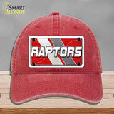 Red cap with 'RAPTORS' logo on a gray background