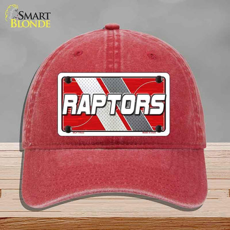 Red cap with 'RAPTORS' logo on a gray background