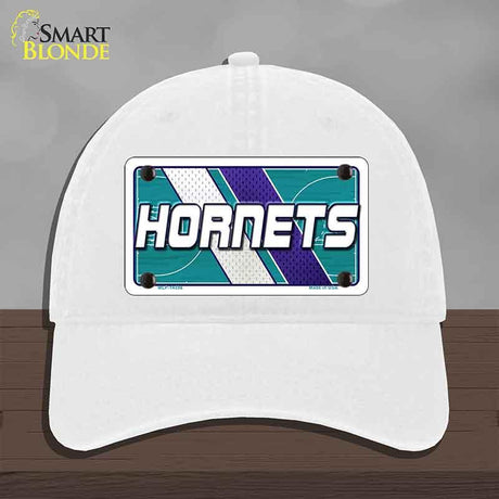 White cap with Hornets logo on a gray background