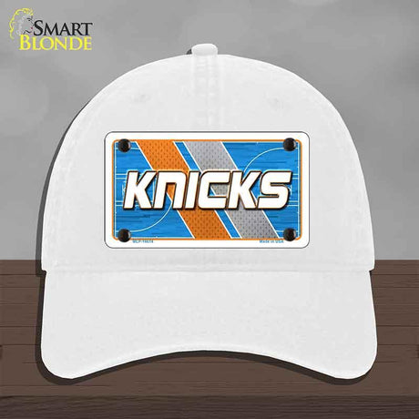 White cap with 'Knicks' design on a gray background