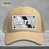 Beige cap with 'NETS' logo on a gray background