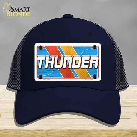 Navy blue cap with 'THUNDER' design on a gray background