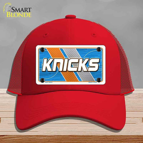 Red cap with 'Knicks' design on a gray background