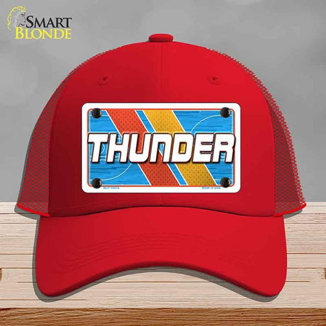 Red cap with 'THUNDER' design on a gray background