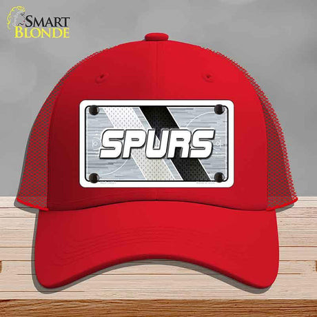 Red cap with 'SPURS' logo on a gray background