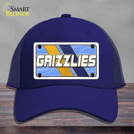 Blue cap with 'GRIZZLIES' logo on a wooden surface and gray background