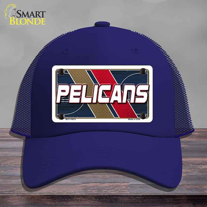 Blue cap with 'Pelicans' design on a wooden surface
