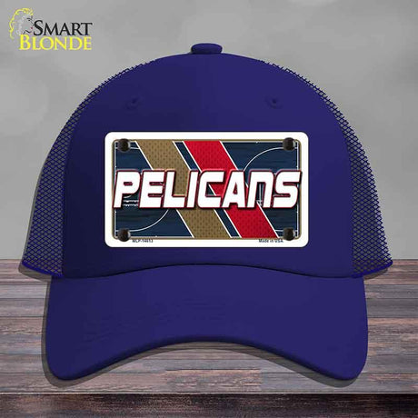 Blue cap with 'Pelicans' design on a wooden surface