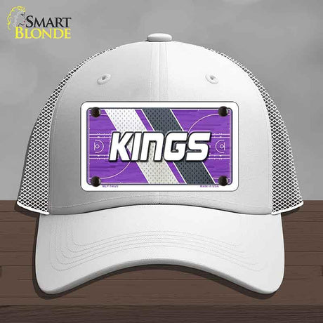 White cap with a purple and gray 'KINGS' logo on a wooden surface