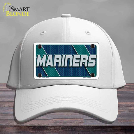 White cap with 'Mariners' logo on a wooden surface