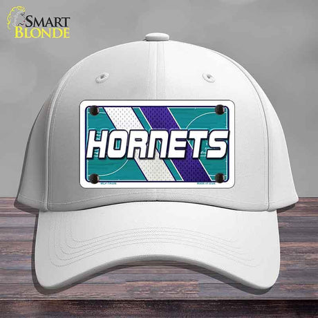 White cap with Hornets logo on a gray background