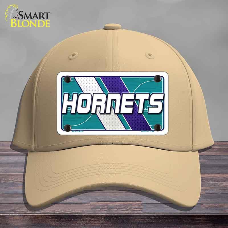 Beige cap with Hornets logo on a wooden surface