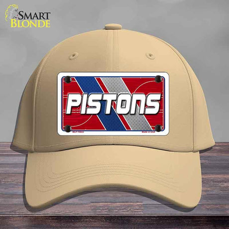 Beige cap with a 'Pistons' license plate design on a wooden surface
