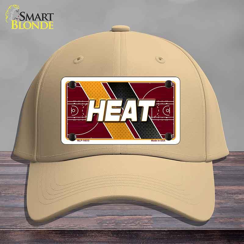 Beige cap with 'HEAT' design on a wooden surface