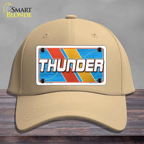 Beige cap with a 'THUNDER' license plate design on a wooden surface.