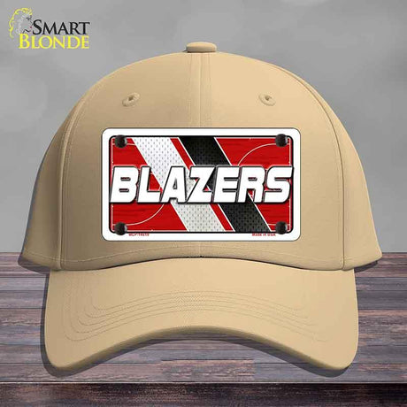 Beige cap with a 'BLAZERS' license plate design on a wooden surface.