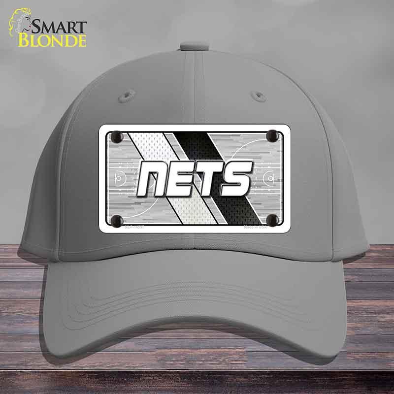 Gray cap with 'NETS' logo on a wooden surface and gray background