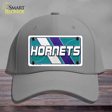 Gray cap with Hornets logo on a wooden surface and gray background