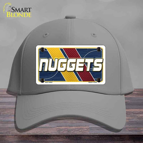 Gray cap with a 'NUGGETS' license plate design on a wooden surface.