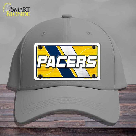 Gray cap with a 'Pacers' logo on a wooden surface