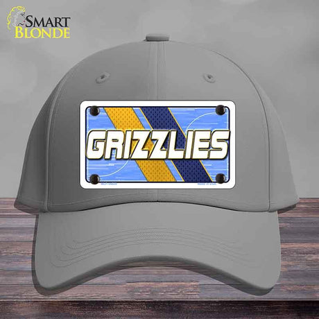 Gray cap with a 'GRIZZLIES' license plate design on a wooden surface.