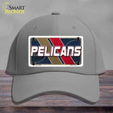 Gray cap with a 'Pelicans' license plate design on a wooden surface