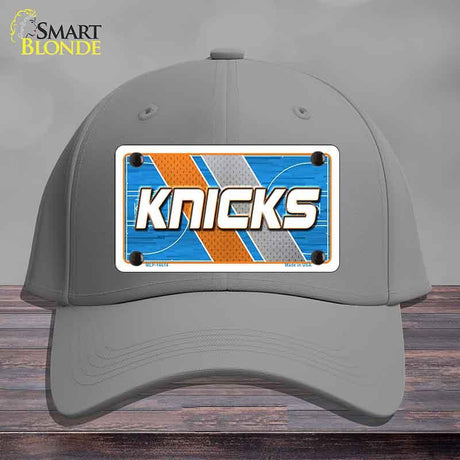 Gray cap with a 'Knicks' license plate design on a wooden surface