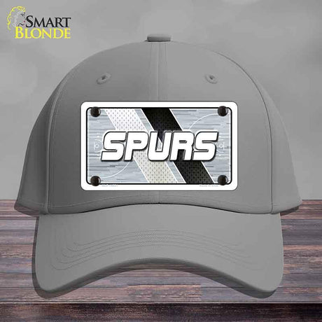 Gray cap with 'SPURS' logo on a wooden surface