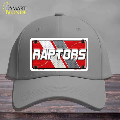 Gray cap with a 'Raptors' logo on a wooden surface