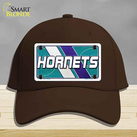 Brown cap with Hornets logo on a gray background