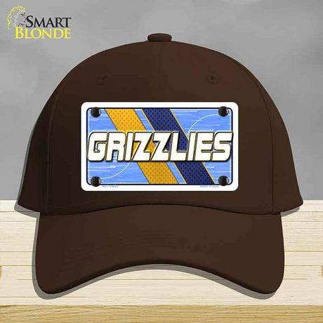 Brown cap with 'GRIZZLIES' license plate design on a gray background