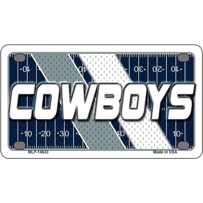 Metallic plate with 'COWBOYS' text on a football field design
