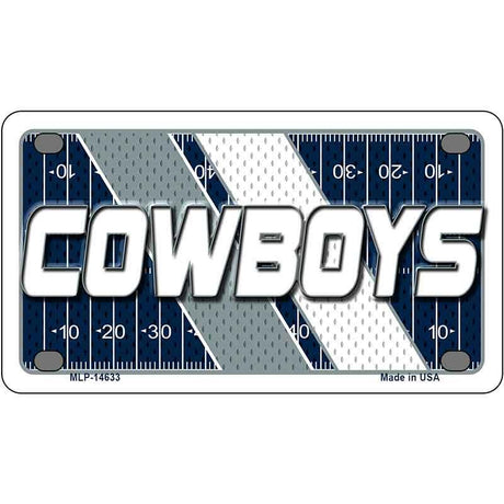Metallic plate with 'COWBOYS' text on a football field design
