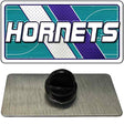 Black rubber stopper on a gray card with 'Hornets' logo in the background