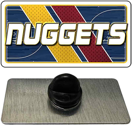 Metallic badge with 'NUGGETS' logo on a reflective surface
