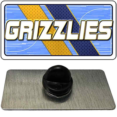 Metallic 'Grizzlies' logo on a blue and gold background with a black object below.