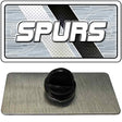 Black rubber stopper on a gray mat with 'SPURS' logo in the background